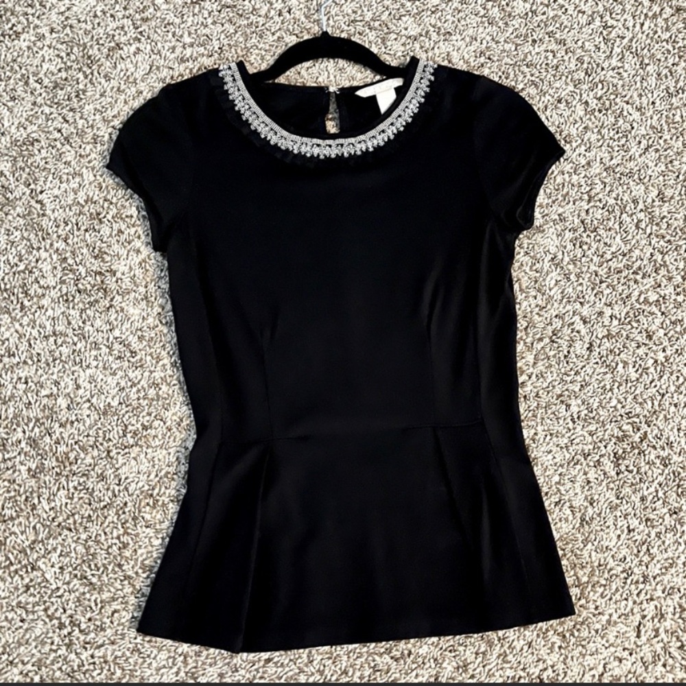 Embellished peplum top.